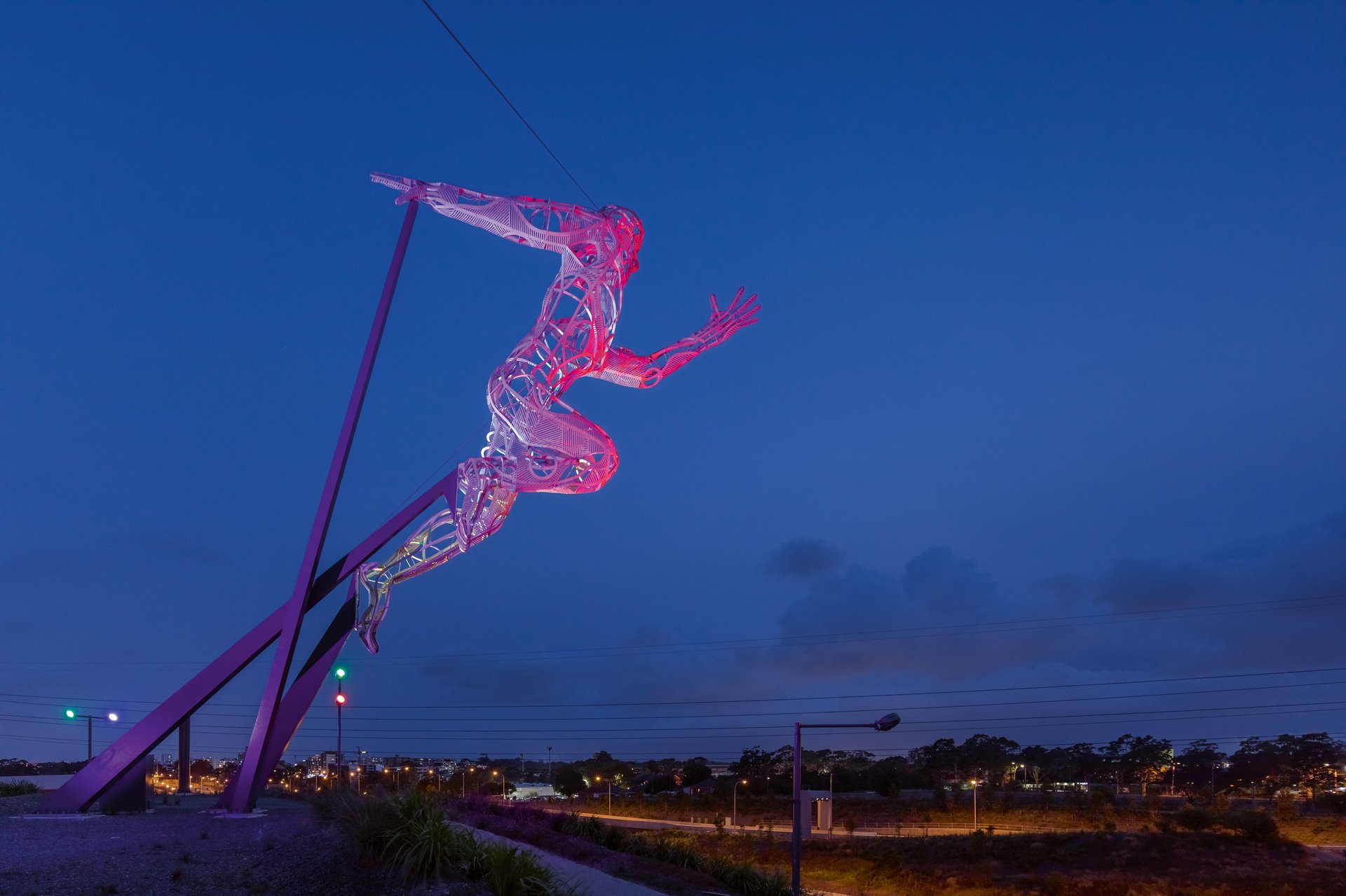Olympic athlete sculpture lit with precision architectural lighting highlighting intricate steel framework and depth lines using WE-EF RGBW LED technology