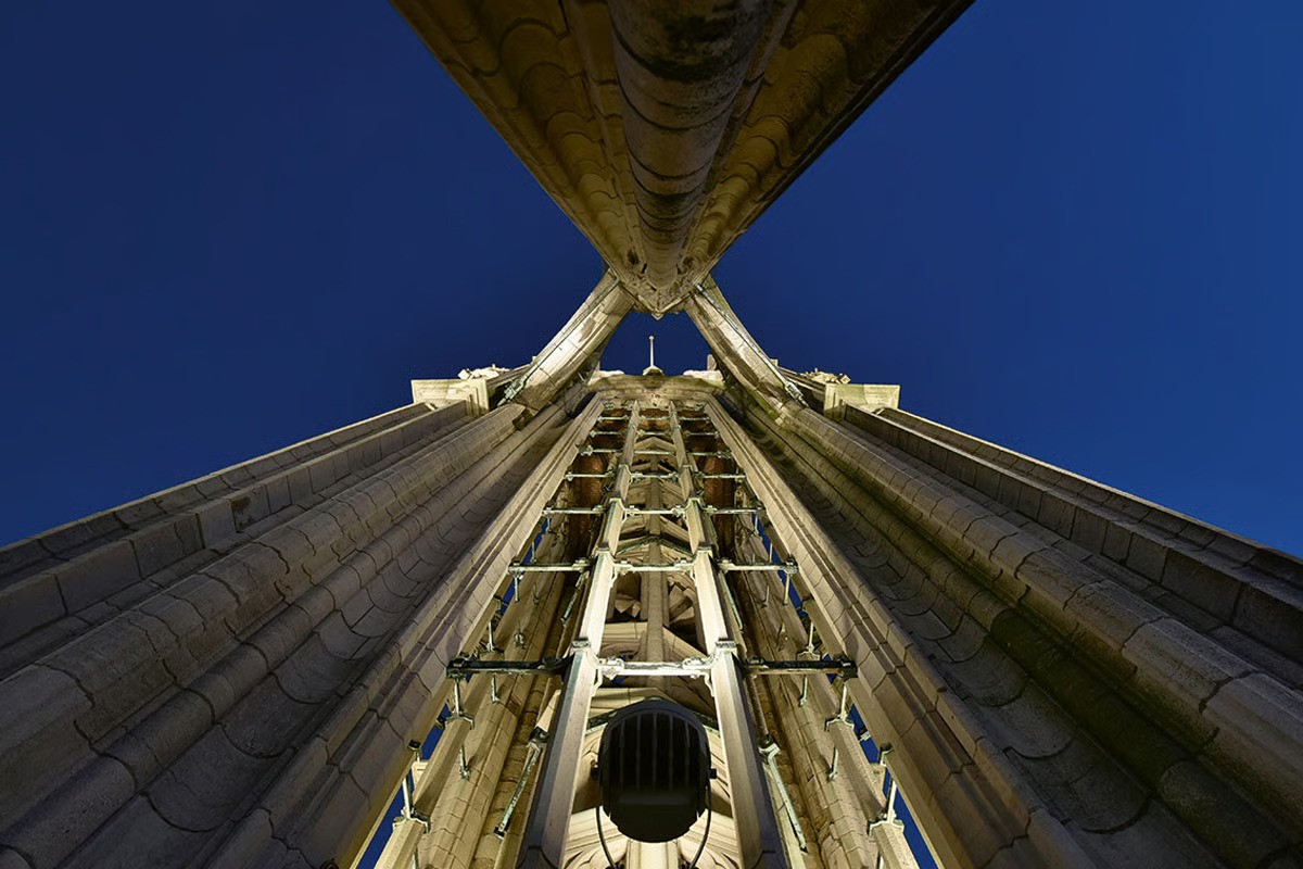 WE-EF FLC projectors with flood and wallwash lenses illuminating Gothic tower buttresses and ornamental stonework Cathedral Antwerp 2019 IALD Award winner