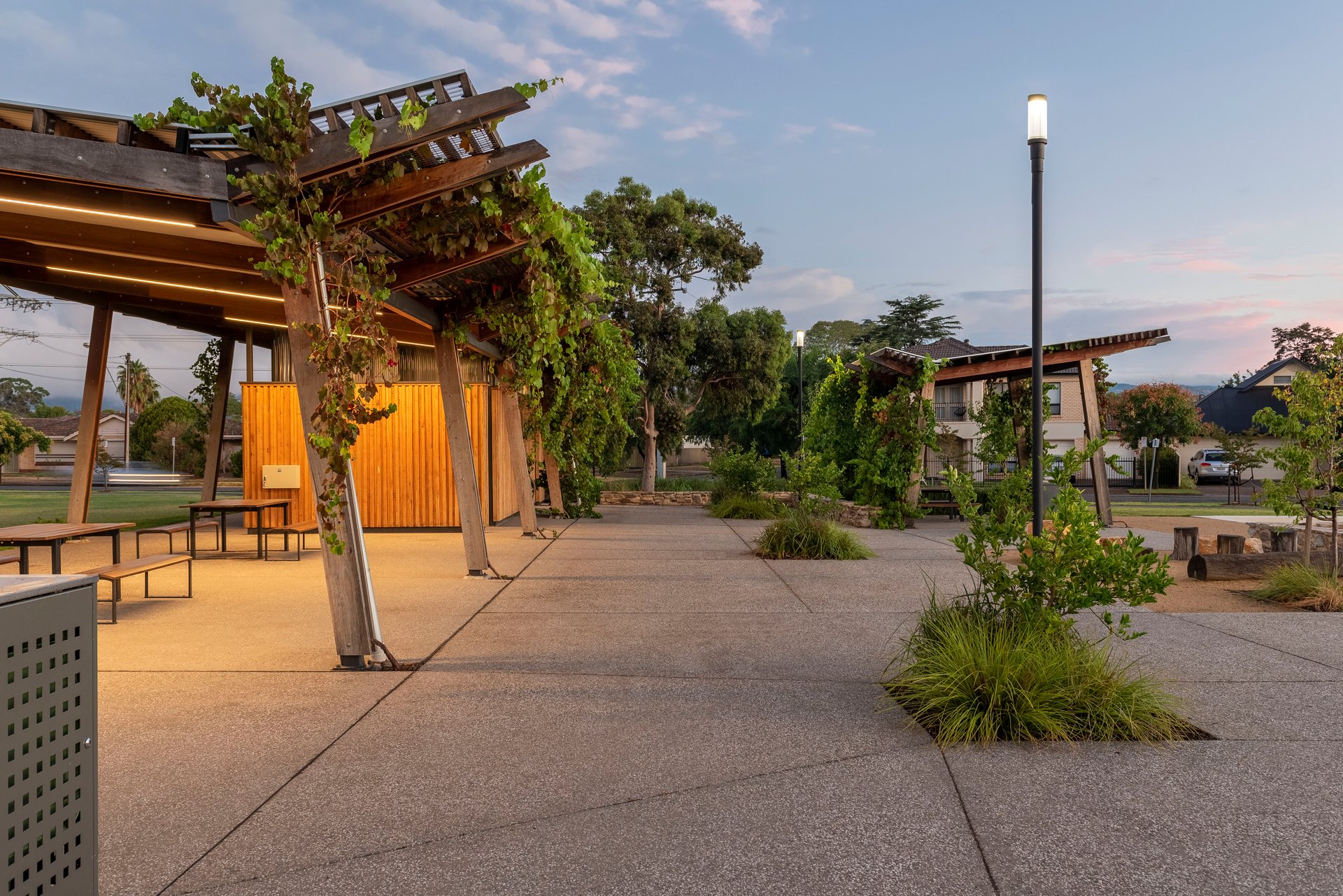 Felixstow Reserve community timber shelter pavilion with WE-EF ZFT400 lantern-style LED luminaire, award-winning landscape design celebrating site's natural features and Indigenous heritage including 200-year-old bark canoe made from fallen River Red Gum on Fourth Creek/Marriyarta Pari banks, completed 2018 redevelopment receiving 11+ prizes including IES Lighting Society commendation for lighting design by Buckford Illumination Group SA