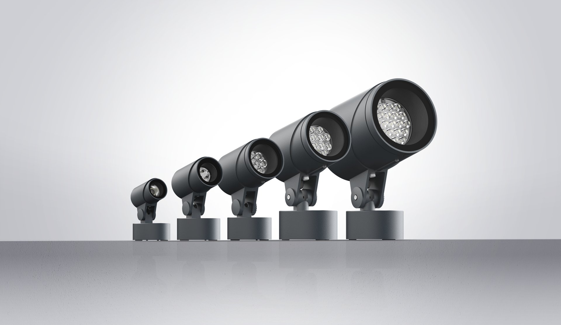 LED‑Außenstrahler der FLC300 Serie in verschiedenen Baugrößen, linear angeordnet, mit zylindrischem Gehäuse für präzise Architektur‑ und Objektbeleuchtung.